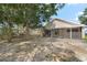 Large private backyard featuring a screened lanai and mature trees providing ample shade at 9145 Fort Jefferson Blvd, Orlando, FL 32822