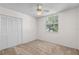 Bedroom featuring neutral carpet, a ceiling fan, closet, and an exterior window at 9145 Fort Jefferson Blvd, Orlando, FL 32822