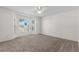 Bright bedroom with neutral carpeting, ceiling fan and bay window overlooking front yard at 9145 Fort Jefferson Blvd, Orlando, FL 32822