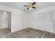 Bedroom featuring neutral carpet, a ceiling fan, closet and an entry door at 9145 Fort Jefferson Blvd, Orlando, FL 32822