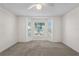 Bright, spacious bedroom with neutral carpet, ceiling fan, and large bay window with neighborhood view at 9145 Fort Jefferson Blvd, Orlando, FL 32822