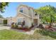 Charming two-story home with a well-maintained lawn, vibrant landscaping, and a welcoming entrance at 9145 Fort Jefferson Blvd, Orlando, FL 32822
