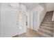 Inviting foyer with tile flooring, staircase, and entry door with sidelight window at 9145 Fort Jefferson Blvd, Orlando, FL 32822