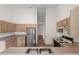 Kitchen featuring stainless steel fridge, wooden cabinetry, and tiled floors at 9145 Fort Jefferson Blvd, Orlando, FL 32822