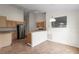 Kitchen featuring stainless steel fridge, wooden cabinetry, and tiled floors at 9145 Fort Jefferson Blvd, Orlando, FL 32822