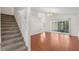 Bright living room featuring wood floors, staircase to second floor, and sliding doors to the backyard at 9145 Fort Jefferson Blvd, Orlando, FL 32822