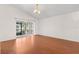 Open-concept living room features wood floors, recessed lighting and sliding glass door to backyard at 9145 Fort Jefferson Blvd, Orlando, FL 32822