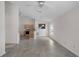 Open living space with tiled floors, ceiling fan and a view to kitchen area with appliances at 9145 Fort Jefferson Blvd, Orlando, FL 32822
