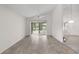 Open living space with tile flooring, ceiling fan, and sliding doors to the outside at 9145 Fort Jefferson Blvd, Orlando, FL 32822