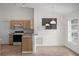 Open living space with tiled floors and a view to kitchen area with appliances at 9145 Fort Jefferson Blvd, Orlando, FL 32822