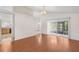 Bright living room featuring wood floors, view into kitchen and sliding doors to the backyard at 9145 Fort Jefferson Blvd, Orlando, FL 32822