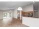 Open living space with tiled floors, ceiling fan and a view to kitchen area with appliances at 9145 Fort Jefferson Blvd, Orlando, FL 32822