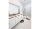 Spacious bathroom featuring a shower with glass doors and double vanity at 949 Leader St, Davenport, FL 33896