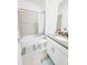 Neutral bathroom featuring tub with shower and gray countertop at 949 Leader St, Davenport, FL 33896
