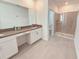 Bathroom with a double vanity, stone countertop, and glass enclosed shower at 949 Leader St, Davenport, FL 33896