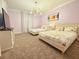 Bedroom with two beds, pastel walls, and modern lighting fixture at 949 Leader St, Davenport, FL 33896