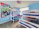 Fun bedroom featuring themed wallpaper and carpet along with two bunk beds at 949 Leader St, Davenport, FL 33896