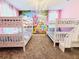 Spacious bedroom with two bunk beds, a princess wall mural, and plush carpet at 949 Leader St, Davenport, FL 33896