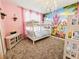 Charming bedroom with bunk beds, a princess-themed mural, and a soft, plush carpet at 949 Leader St, Davenport, FL 33896