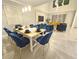Bright dining room featuring a white table set for eight, chandelier and modern furnishings at 949 Leader St, Davenport, FL 33896