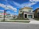Beautiful home with a stone facade, green garage door, green lawn and landscaping, in a sidewalk community at 949 Leader St, Davenport, FL 33896