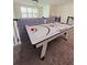 Spacious game room with air hockey table and modern hanging lights at 949 Leader St, Davenport, FL 33896