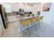 Modern kitchen with white cabinets, gray countertops, stainless steel appliances and counter seating at 949 Leader St, Davenport, FL 33896