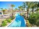 Beautiful lazy river winding through lush landscaping and palm trees in a resort-style community at 949 Leader St, Davenport, FL 33896