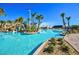 Dive into relaxation at the community pool, framed by swaying palms and a vibrant blue sky at 949 Leader St, Davenport, FL 33896