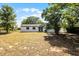 Large backyard featuring mature trees and a view of the back side of the home at 1859 Matterhorn Dr, Orlando, FL 32818