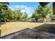 Large backyard featuring a concrete patio and mature trees with a view of neighboring properties at 1859 Matterhorn Dr, Orlando, FL 32818
