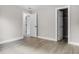 Spacious bedroom featuring wood floors and open closet and doorway for flow at 1859 Matterhorn Dr, Orlando, FL 32818