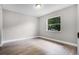This bright bedroom offers wood floors, a large window, and natural light at 1859 Matterhorn Dr, Orlando, FL 32818