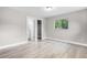 Bright bedroom features wood floors, closet with open door, and a view of nature outside at 1859 Matterhorn Dr, Orlando, FL 32818