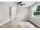 Spacious bedroom with a ceiling fan, wood floors, large window, and freshly painted walls at 1859 Matterhorn Dr, Orlando, FL 32818