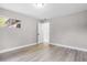 This bedroom has wood-look flooring, neutral walls, and a door leading to another room at 1859 Matterhorn Dr, Orlando, FL 32818