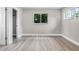 Bright bedroom features wood-look flooring and a window view of the trees outside at 1859 Matterhorn Dr, Orlando, FL 32818