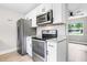 Modern kitchen boasting stainless steel appliances, white cabinets, and beautiful backsplash at 1859 Matterhorn Dr, Orlando, FL 32818