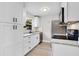 Modern kitchen featuring sleek white cabinets, granite countertops, and stainless steel appliances at 1859 Matterhorn Dr, Orlando, FL 32818
