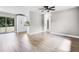 Open living room with wood flooring, access to the yard, and an adjacent modern kitchen at 1859 Matterhorn Dr, Orlando, FL 32818