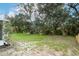 Scenic backyard with mature trees and a manicured lawn with a screened-in porch visible at 1077 Dees Dr, Oviedo, FL 32765