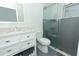 This bathroom features a glass shower, white marbled vanity, and gray color scheme at 1077 Dees Dr, Oviedo, FL 32765