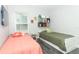 Bright bedroom featuring two twin beds with gray flooring and neutral walls at 1077 Dees Dr, Oviedo, FL 32765