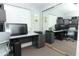 View of the home office with natural light, multiple monitors, and two working spaces at 1077 Dees Dr, Oviedo, FL 32765