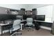 Home office equipped with multiple monitors, built in shelves, and two desk spaces at 1077 Dees Dr, Oviedo, FL 32765