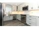 Updated kitchen with stainless steel appliances, modern cabinets, and a bright countertop at 1077 Dees Dr, Oviedo, FL 32765
