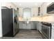 Stylish kitchen featuring stainless steel appliances, bright countertops, and modern grey cabinets at 1077 Dees Dr, Oviedo, FL 32765