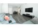 Living room showcasing an open floor plan with modern flooring, a sectional sofa, and a large TV at 1077 Dees Dr, Oviedo, FL 32765