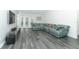 Spacious living room featuring stylish flooring, and a comfortable sectional sofa at 1077 Dees Dr, Oviedo, FL 32765
