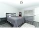 The main bedroom has gray wood flooring and a modern color scheme with a window for lots of sunlight at 1077 Dees Dr, Oviedo, FL 32765